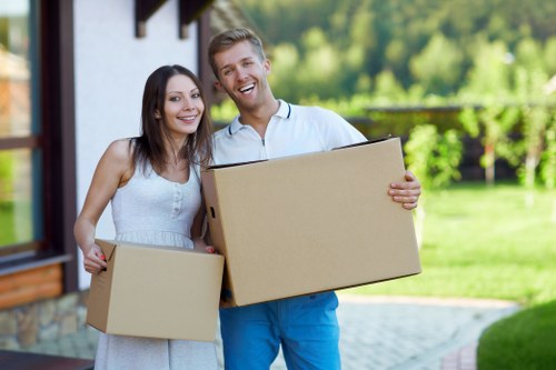 Packed household boxes and furniture ready for loading during a Teddington move