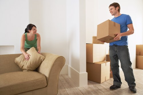 Removal crew carrying furniture from a Teddington home