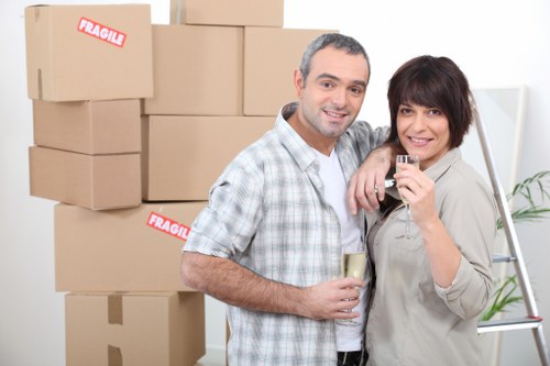 Professional movers handling furniture in a Teddington residential street